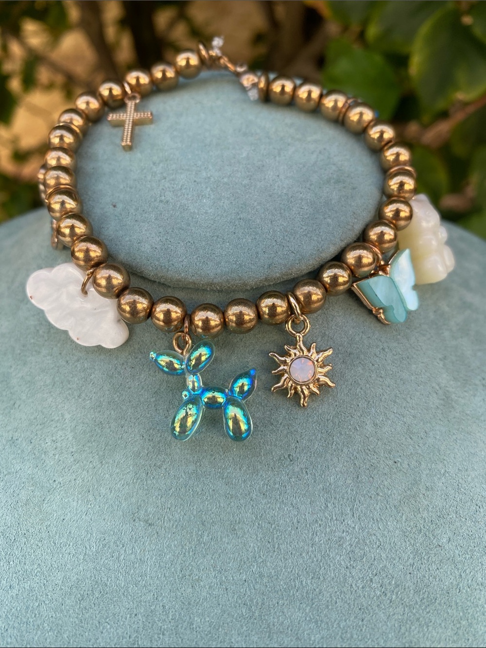 Gold toned Beaded Charm Bracelet with Blue Iridescent Balloon Dog and Sun Accent